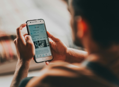 Image of a person reading news on the internet