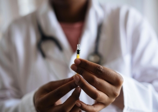 Doctor holding injection